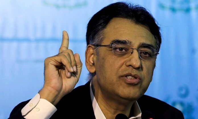FILE PHOTO: Pakistan's Finance Minister Asad Umar gestures during a news conference in Islamabad